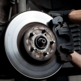 10387786 - closeup of car mechanic repairing brake pads