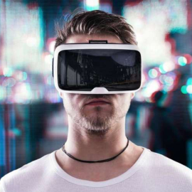 Man wearing virtual reality goggles against night city